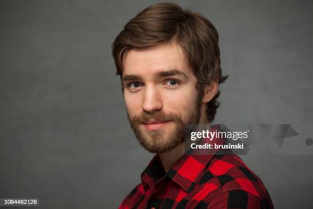 studio portrait of a 25 year old man - red plaid stock pictures, royalty-free photos & images