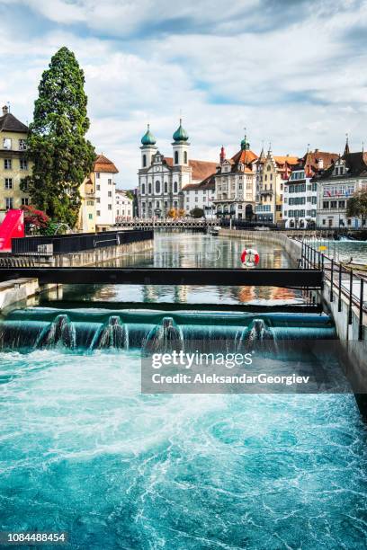 jesuit church and reuss river in old town lucerne, switzerland - luzern stock pictures, royalty-free photos & images