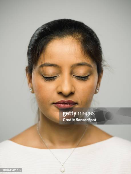 real indian young woman with blank expression and closed eyes - face eyes closed stock pictures, royalty-free photos & images