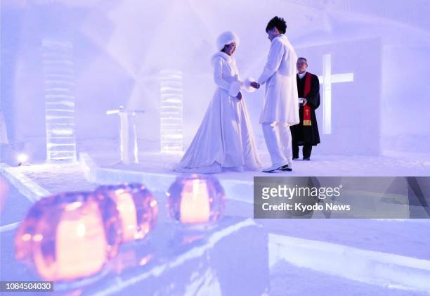 Couple hold a wedding ceremony in the "Ice Chapel" at the Ice Village of Hoshino Resorts Tomamu in Shimukappu, Hokkaido, during a press preview on...