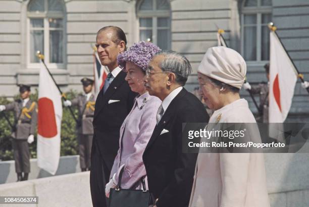 Queen Elizabeth II pictured standing together with, from left, Price Philip Duke of Edinburgh, Emperor Hirohito of Japan and Empress Nagako outside...