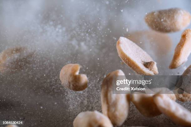 peanuts roasted with salt jumping captured with high speed shutter - fast shutter speed stock-fotos und bilder