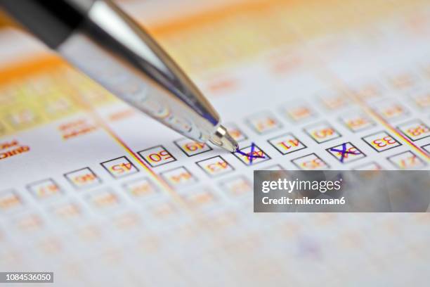 pen markings on lottery ticket. filled in lottery ticket - loto photos et images de collection