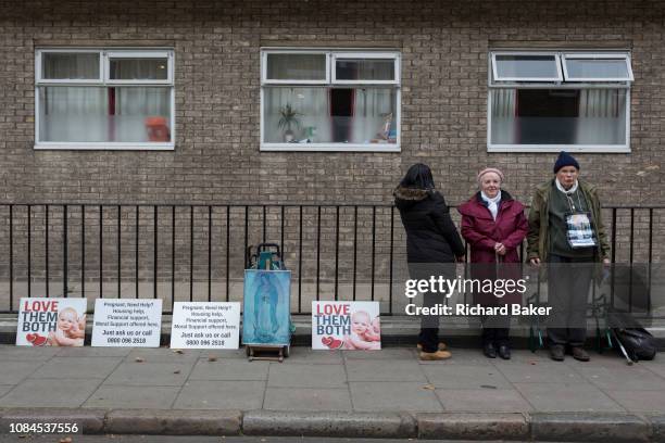 Three anti-abortion campaigners stand vigil opposite Marie Stopes International in Whitfield Street, W1, on 16th January 2019, in London, England.