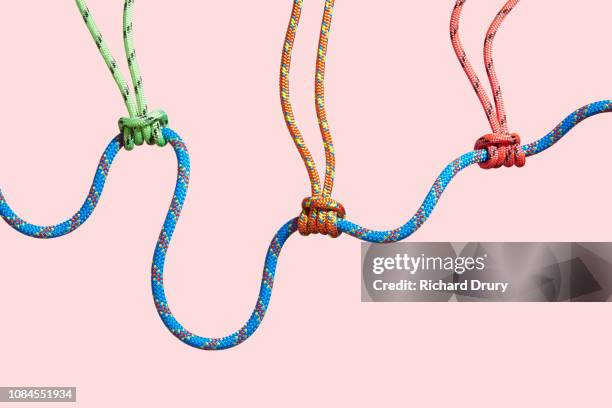 four coloured ropes supporting a larger rope - tied knot stock pictures, royalty-free photos & images