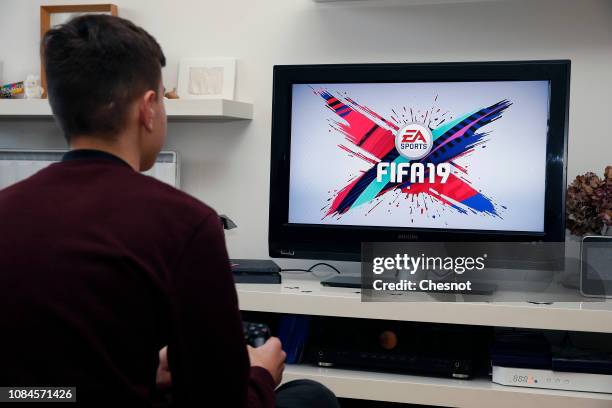 In this photo illustration a gamer plays the video game ‘FIFA 19' developed and published by Electronic Arts on a Sony PlayStation game console PS4...