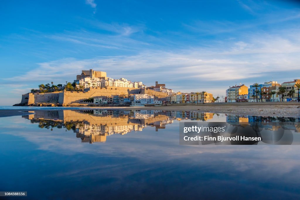 Peñiscola Fortress - Castillo de Peñíscola Spain  - with reflection in a small pond at the beach in the golden hour