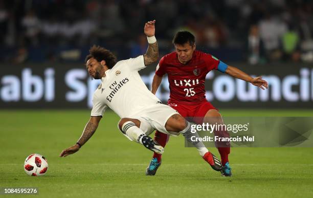Yasushi Endo of Kashima Antlers tackles Marcelo of Real Madrid during the FIFA Club World Cup semi-final match between Kashima Antlers and Real...