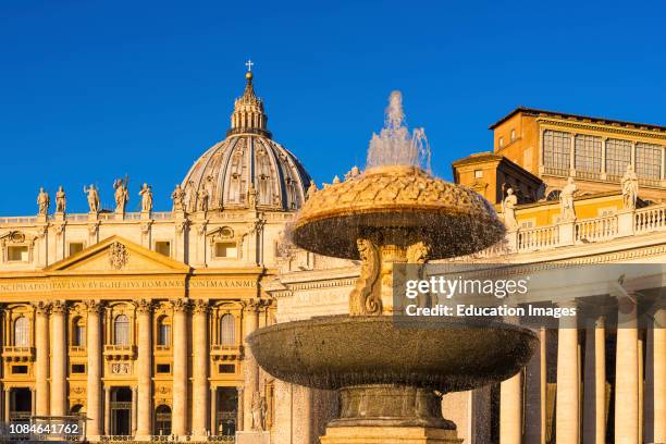 Berninis fountains at St Peters square in early morning light, Vatican City, Rome, Italy.