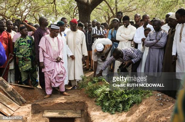 Mourners stand at the grave to pray and bury Ghanaian undercover journalist Ahmed Husein Suale killed for exposing corruption in African football...