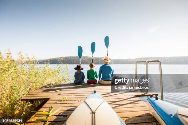 father and two sons playing on pier - 11 loch stock pictures, royalty-free photos & images