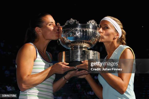 Gisela Dulko of Argentina and Flavia Pennetta of Italy kiss the trophy after winning the Women's doubles final match against Maria Kirilenko of...