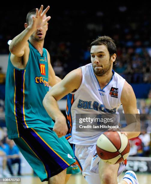 Adam Gibson of the Blaze drives past Russell Hinder of the Crocodiles during the round 16 NBL match between the Townsville Crocodiles and the Gold...