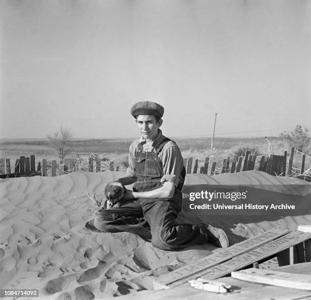 Farmer Son Playing on Soil Drift that Threatens to cover up his Home, Liberal, Kansas, USA, Arthur Rothstein, Farm Security Administration, March...