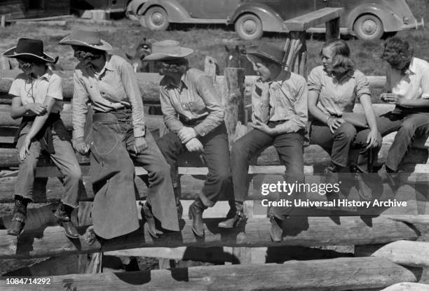 Dude Girls on a Corral Fence, Quarter Circle U Roundup, Montana, USA, Arthur Rothstein, Farm Security Administration, June 1939.