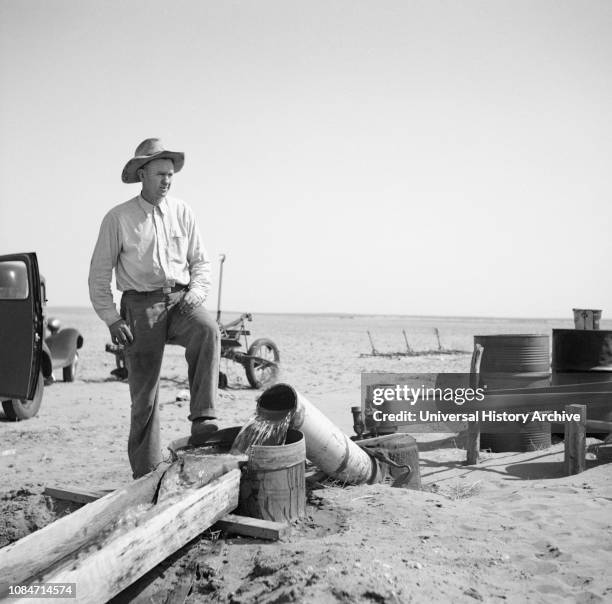 Farmer Pumping Water from Well to Parched Fields during Drought, Cimarron County, Oklahoma, USA, Arthur Rothstein, Farm Security Administration,...