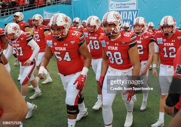 Utah Utes offensive lineman Paul Maile and defensive end Bapa Falemaka head onto the field before the start of the Holiday Bowl played against the...