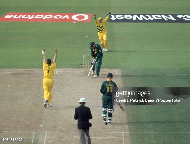 Shaun Pollock of South Africa is bowled for 20 runs by Damien Fleming of Australia during the World Cup Semi Final between Australia and South Africa...