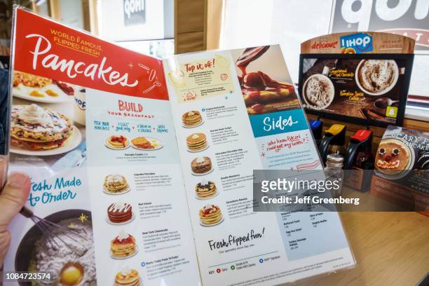 Florida, Gainesville, IHOP, International House Pancakes, holding menu.