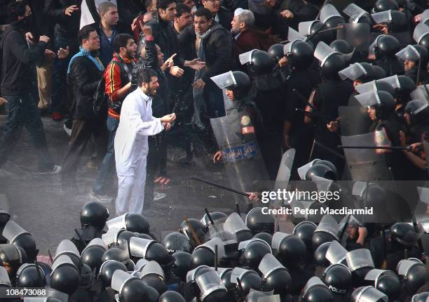 Riot police face protestors on the Kasr Al Nile Bridge on January 28, 2011 in downtown Cairo, Egypt. Thousands of police are on the streets of the...