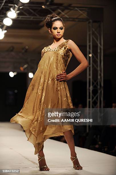 Pakistani model presents a creation by Pakistani designer Bizma during the second day of Islamabad Fashion Week in Islamabad on January 28, 2011....