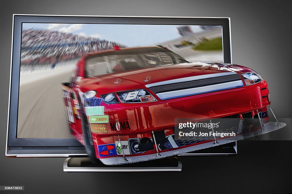 Race car coming out of computer screen