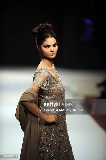 Pakistani model presents a creation by Pakistani designer Bizma during the second day of Islamabad Fashion Week in Islamabad on January 28, 2011....