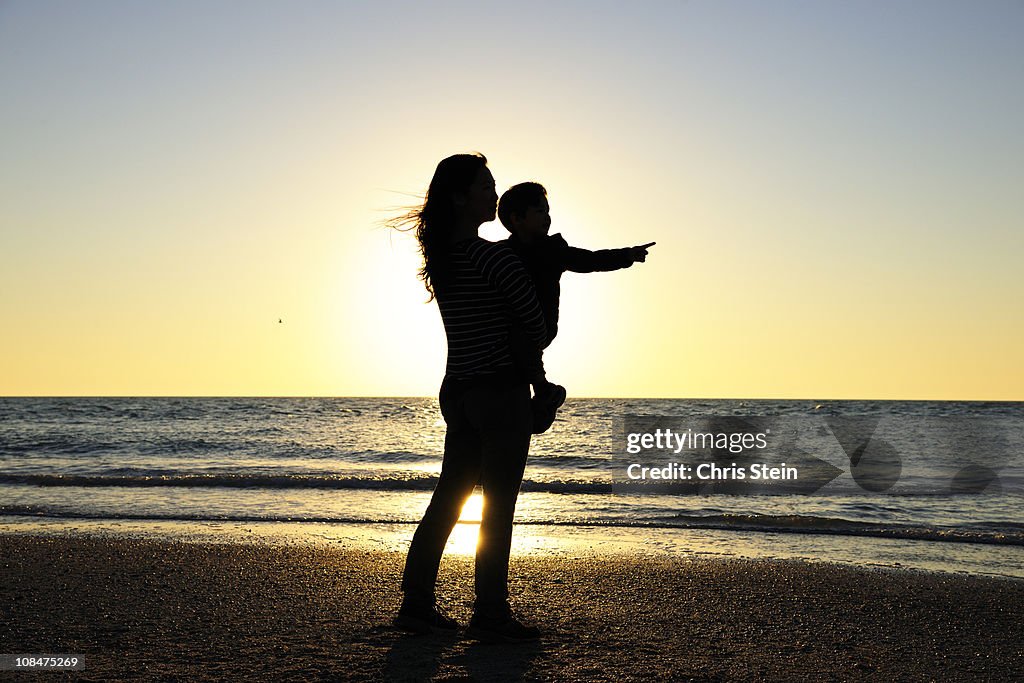 Mother and Son pointing on the beach