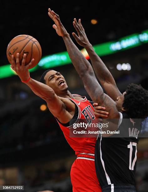 Shaquille Harrison of the Chicago Bulls puts up a shot against Ed Davis of the Brooklyn Nets at the United Center on December 19, 2018 in Chicago,...