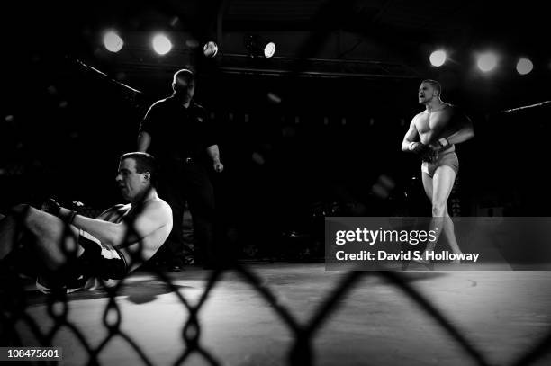 Kris "Savage" McCray, right, celebrates after defeating Robert Conner at Operation Octagon at the Prince William County Fairgrounds in Manassas,...