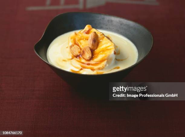 floating island with thinly sliced almonds - floating island stock pictures, royalty-free photos & images