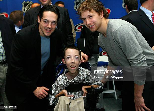 Phildaelphia Flyers players Danny Briere and Claude Giroux pose for a photo with 16-year old Jonathan Crighton during the Lion's Den "Champions in...