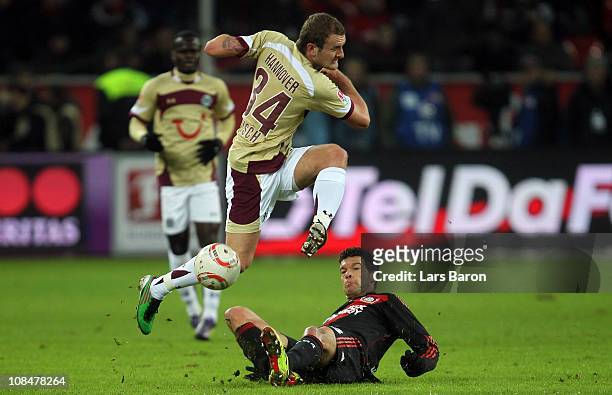 Konstantin Rausch of Hannover is challenged by Michael Ballack of Leverkusen during the Bundesliga match between Bayer Leverkusen and Hannover 96 at...