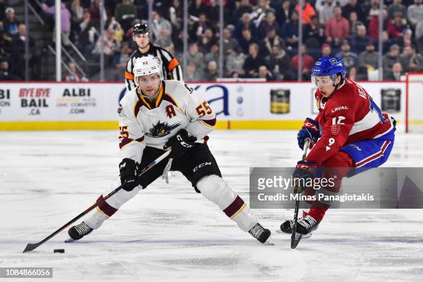 Mark Letestu of the Cleveland Monsters looks to play the puck near Lukas Vejdemo of the Laval Rocket during the AHL game at Place Bell on January 18,...