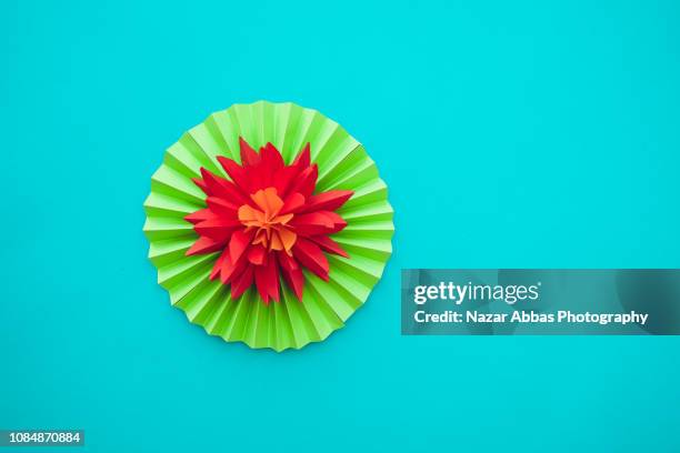 origami flowers on light blue background. - origami flower stock pictures, royalty-free photos & images