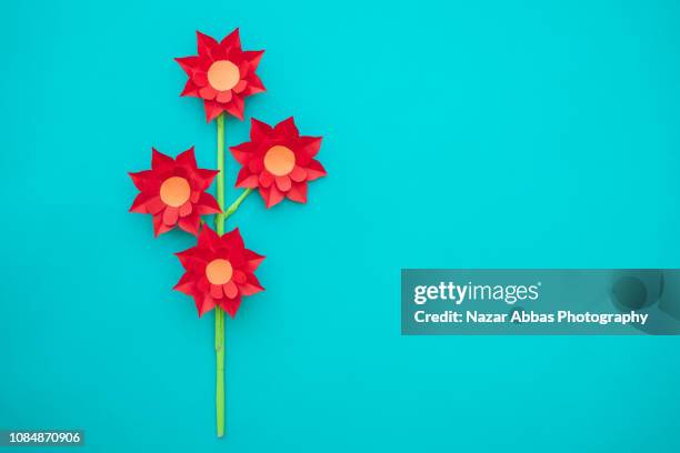 origami flowers on light blue background. - origami flower stock pictures, royalty-free photos & images