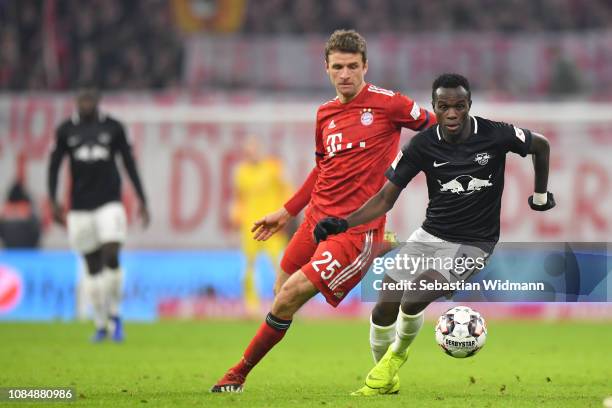 Thomas Mueller of Bayern Munich and Bruma of Leipzig compete for the ball during the Bundesliga match between FC Bayern Muenchen and RB Leipzig at...