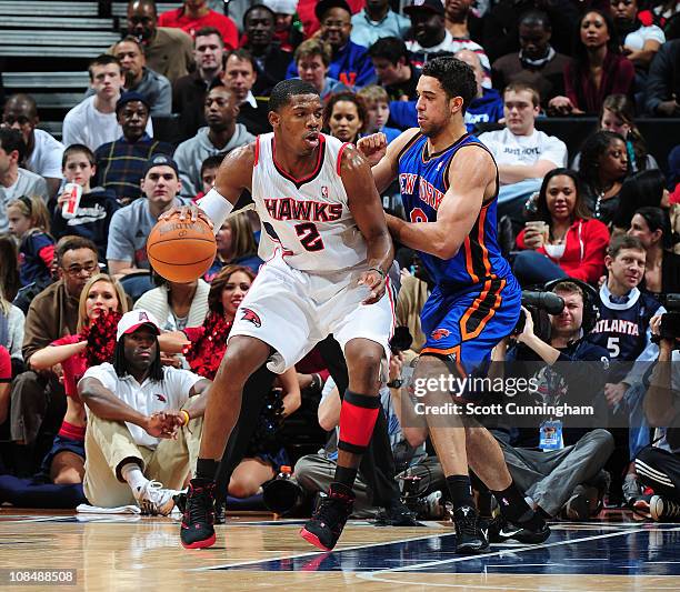 Joe Johnson of the Atlanta Hawks backs down Landry Fields of the New York Knicks during the game on January 28, 2011 at Philips Arena in Atlanta,...