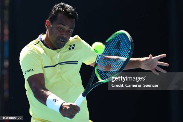 Leander Paes of India plays a backhand in his Mixed Doubles match with Samantha Stosur of Australia against Kveta Peschke and Wesley Koolhof during...