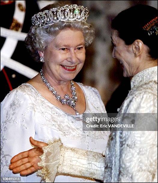 Queen Elizabeth smiles to italian dancer Carla Fracci as she introduces guest at Quirinal presidential palace before the state banquet with Italian...