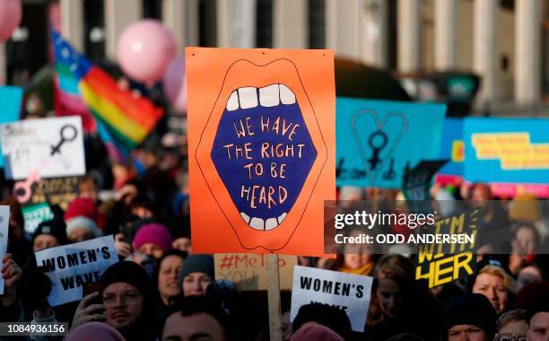 People hold up posters reading among others "We have the right to be heard" as they take part in a Women's March on January 19, 2019 in Berlin. - The...