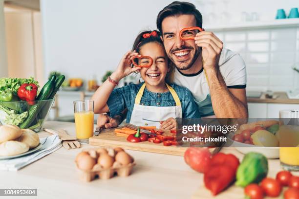 father and daughter looking through pepper slices - child eyes stock pictures, royalty-free photos & images