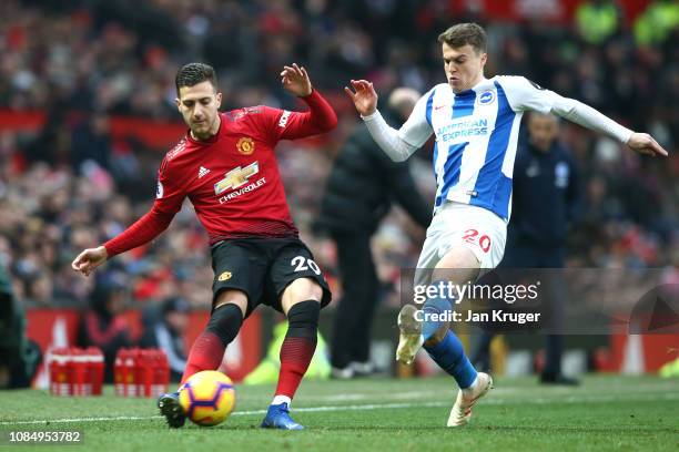 Diogo Dalot of Manchester United passes the ball under pressure from Solomon March of Brighton and Hove Albion during the Premier League match...