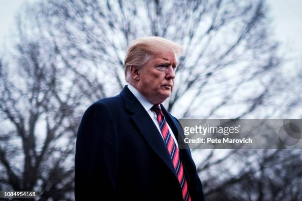 President Donald Trump stops to speak to reporters as he prepared to board Marine One on the South Lawn of the White House on January 19, 2019 in...
