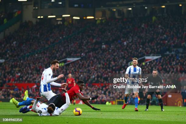 Paul Pogba of Manchester United wins a penalty under a tackle from Gaëtan Bong of Brighton and Hove Albion during the Premier League match between...