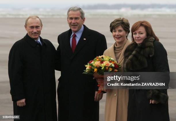 Russia's President Vladimir Putin, U.S. President George W. Bush, the first lady Laura Bush, Putin's wife Lyudmila Putina during a refueling stop at...