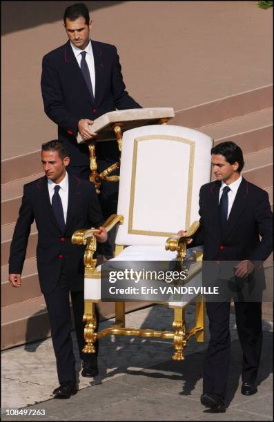 Porter carrying the pope's throne before a ceremony in Rome, Vatican City on May 01, 2003.