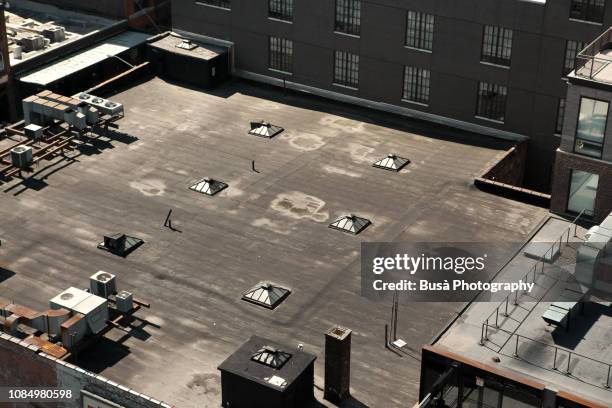 aerial view of rooftop of building with tiny skylights, manhattan, new york city - rooftop hvac stock pictures, royalty-free photos & images