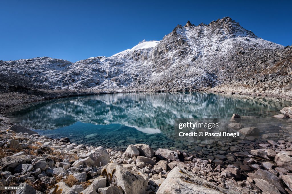 Lake and snowy summit near Rinchen Zoe La, Wangdue Phodrang district, Snowman Trek, Bhutan