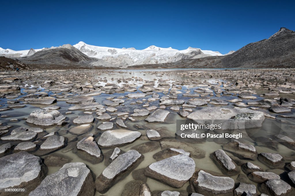High altitude lake and snowcapped mountains, Wangdue Phodrang district, Snowman Trek, Bhutan